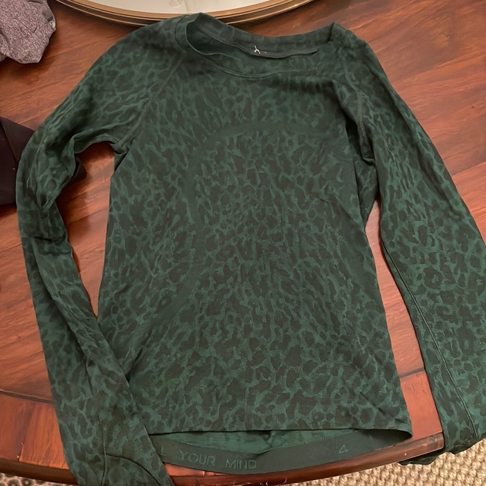 Swiftly tech long sleeve 2.0 race length. size 4. Color is a dark green cheetah